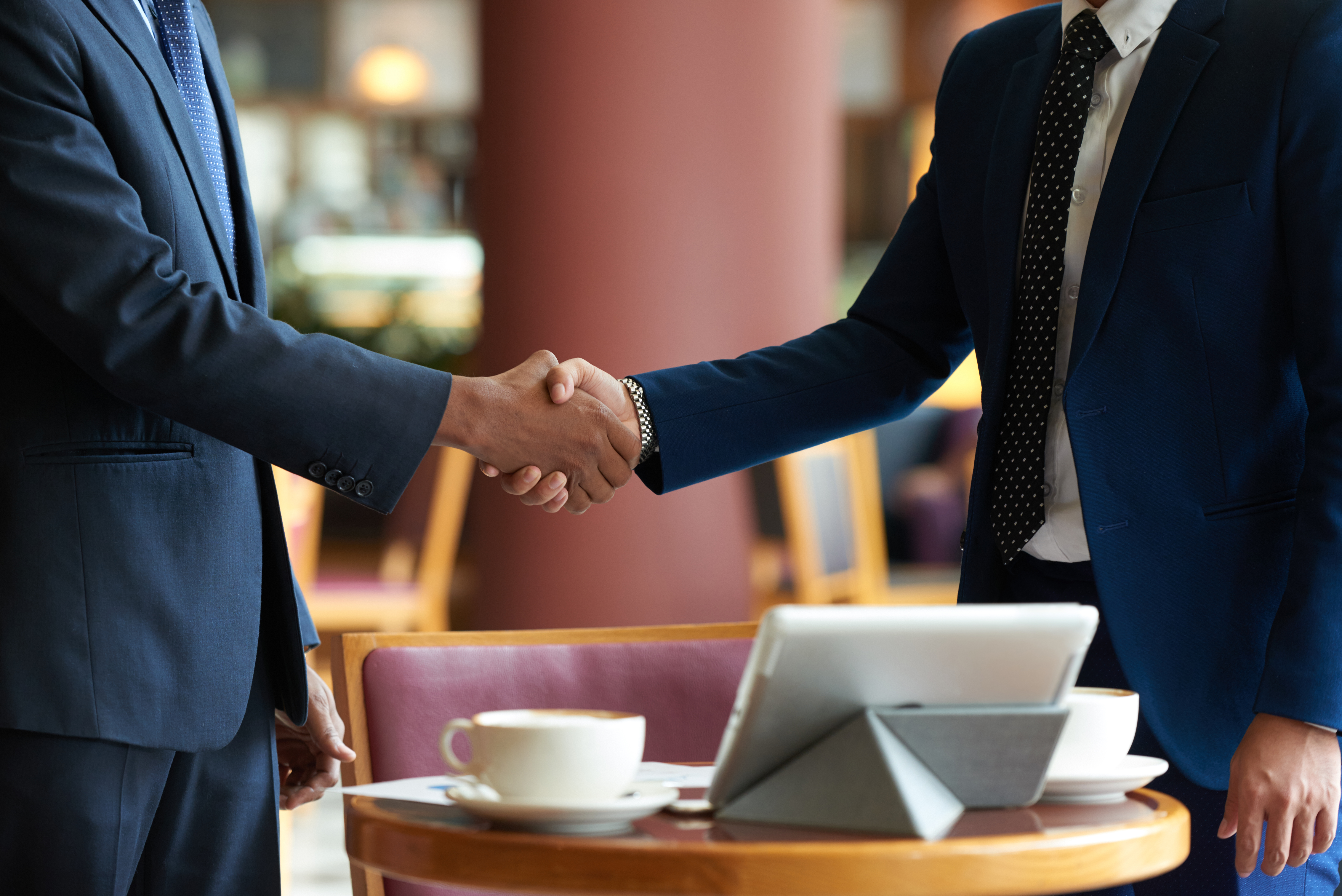 Cropped image of business partners shaking hands